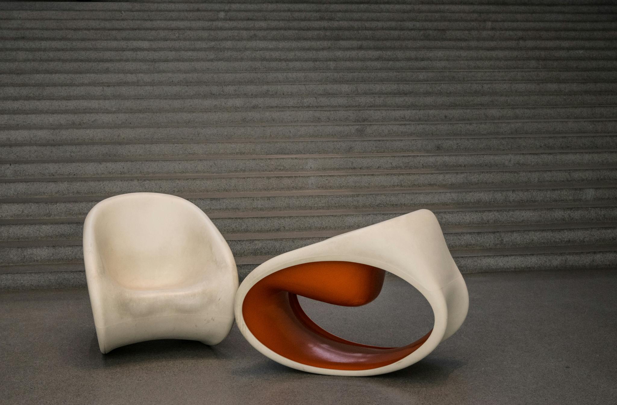 Artistic chairs in a minimalist indoor setting, showcasing modern design.