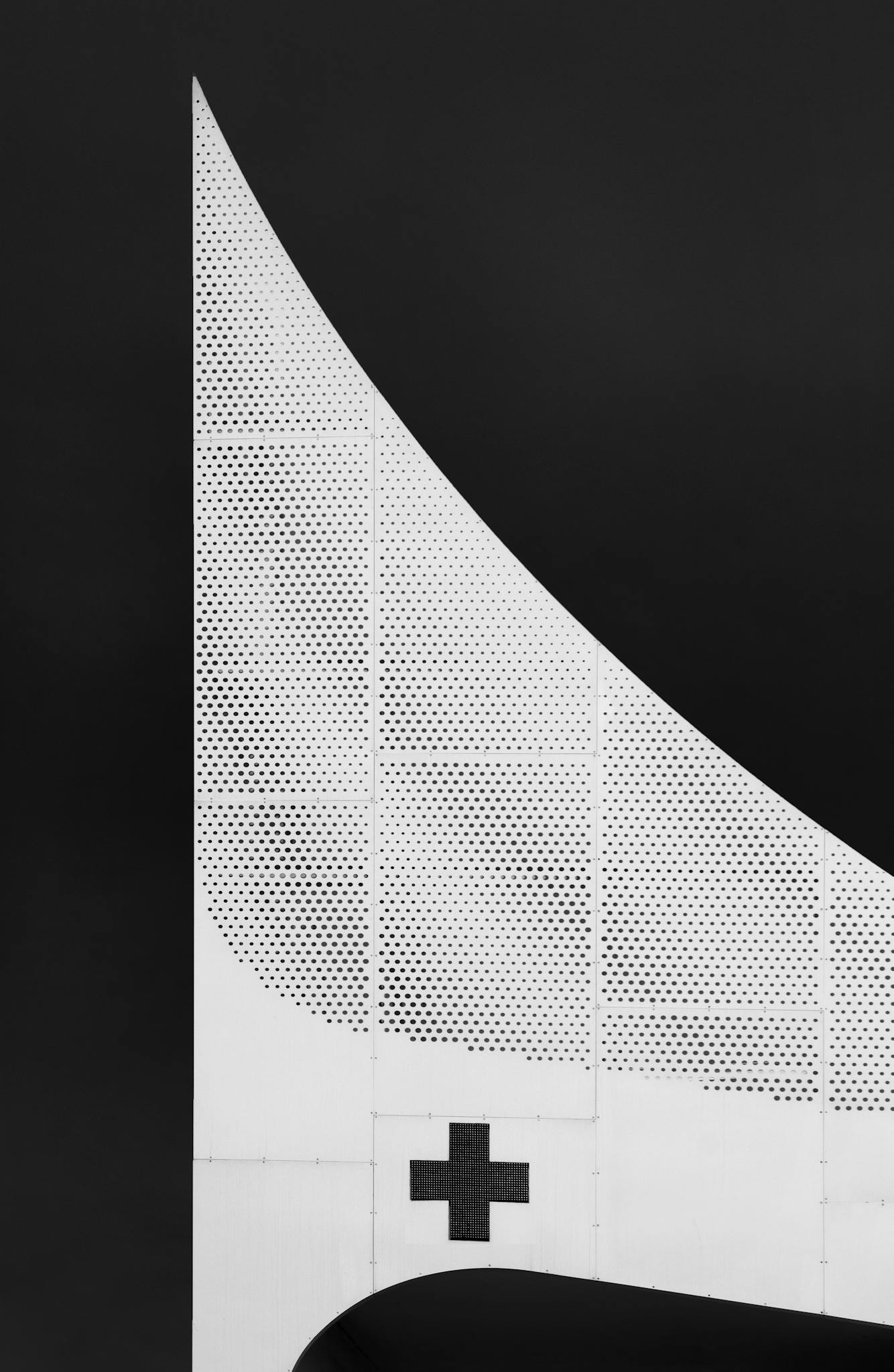 Minimalist black and white abstract architectural structure with a geometric pattern.